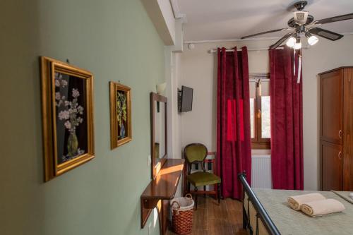 a room with a table and a red curtain at Villa Filyra in Kato Gatzea