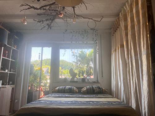 a bed in a room with a window at Chambre dans un appartement in Rollingen