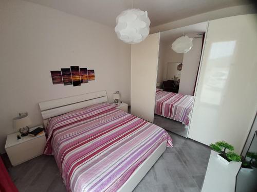 a bedroom with a large bed and a mirror at Mare e Storia da Sabrina in Sassari