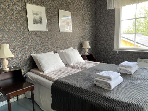 a bedroom with a bed with two towels on it at Vinter Bed & Breakfast in Sauvo