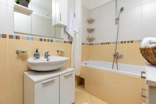 een badkamer met een wastafel en een bad bij Karlita Apartment in Solin