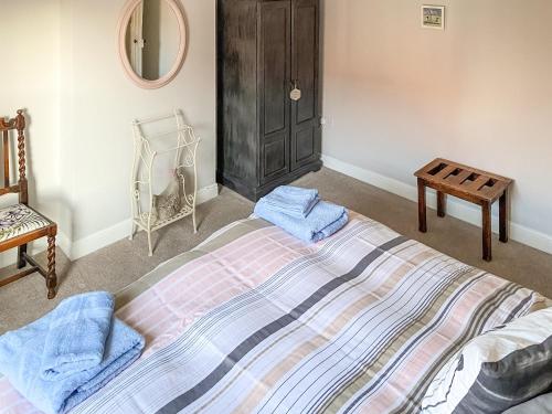 Rubys Retreat في شيرينغهام: غرفة نوم عليها سرير وفوط زرقاء