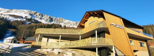 a large building with a staircase in front of a mountain at Ski- und Wanderparadies Brunnalm - Hohe Veitsch 