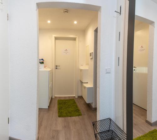 a hallway with a bathroom with a sink and a mirror at #2 Großes Zimmer mit Pool und Garten in Memmingen