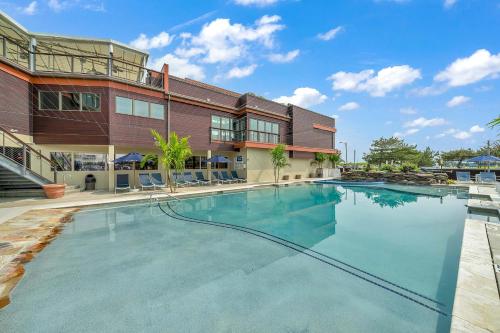a large swimming pool in front of a building at ICONA Windrift in Avalon