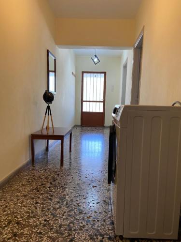 an empty room with a refrigerator and a table at Family apartment with 2 bedrooms to the city center in Kamena Vourla