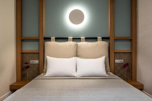 a bed with two white pillows in a room at La Vista Azul - Sea View Apartment in Pláka