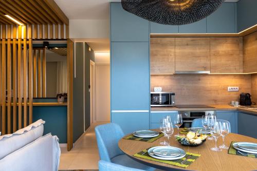 a kitchen and dining room with a table and chairs at La Vista Azul - Sea View Apartment in Pláka