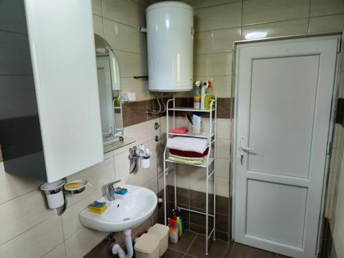a bathroom with a sink and a mirror at Rooms Mery in Visoko