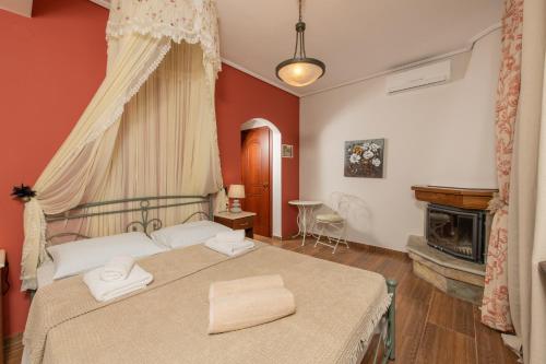 a bedroom with a bed with two towels on it at Villa Filyra in Kato Gatzea