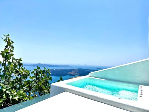 a swimming pool on the side of a house at Eteoro Suites in Imerovigli