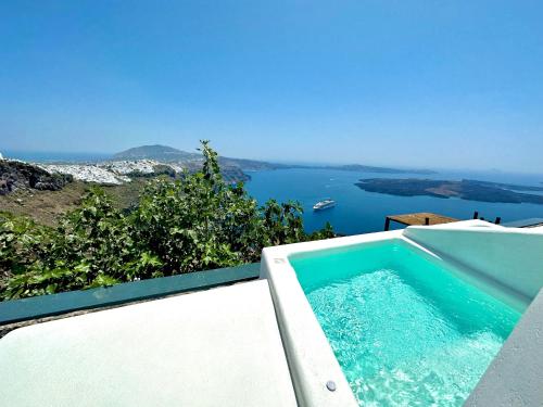 a swimming pool with a view of the water at Eteoro Suites in Imerovigli