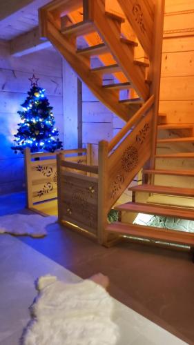 a christmasmas tree in a room with a staircase with a christmas tree at Wood House in Nowy Targ