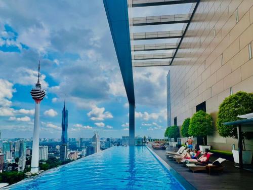 a swimming pool on the roof of a building with a city at Platinum KLCC By Rainbow Suites in Kuala Lumpur