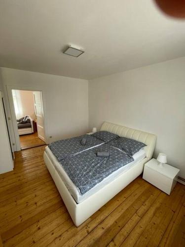 a bedroom with a bed in a room with wooden floors at Apartmán Na Polabí 2 in Mělník