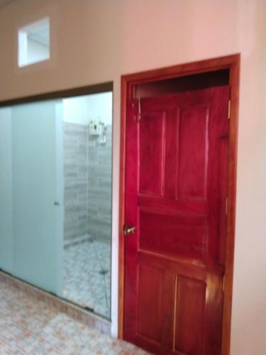 una porta rossa e uno specchio in bagno di Casa Hotel Familiar 