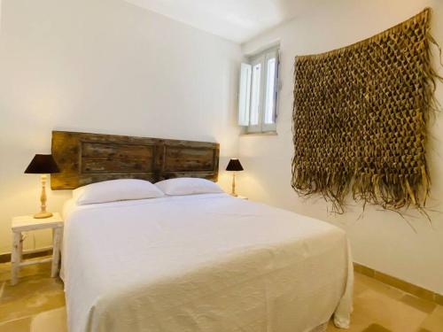 Кровать или кровати в номере Trullo in Fabula ad Alberobello