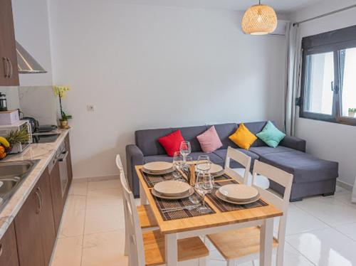 a living room with a table and a blue couch at Doris home in Rhodes Town