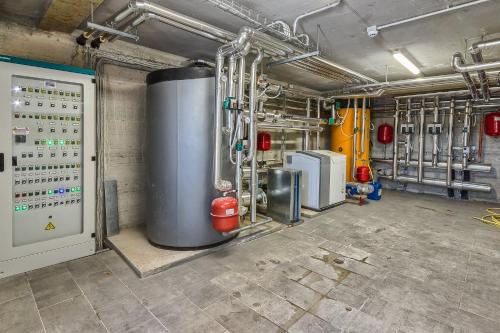 a boiler room with a large metal tank at Agriturismo Colli Martani in Massa Martana
