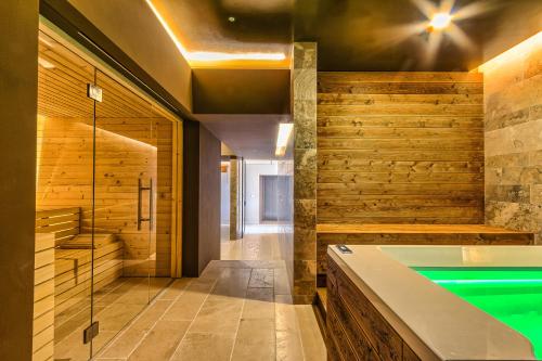 a bathroom with a swimming pool and wooden walls at Agriturismo Colli Martani in Massa Martana