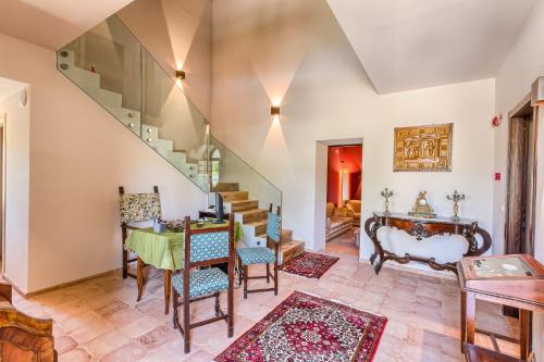 a living room with a staircase and a table and chairs at Agriturismo Colli Martani in Massa Martana