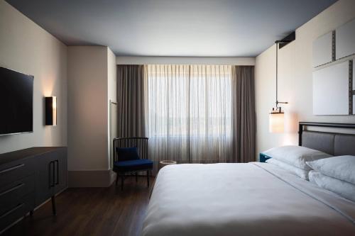 a hotel room with a bed and a television at Renaissance Columbus Westerville-Polaris Hotel in Westerville