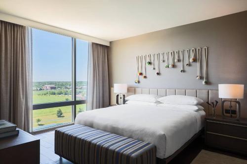 a bedroom with a large bed and a large window at Renaissance Columbus Westerville-Polaris Hotel in Westerville