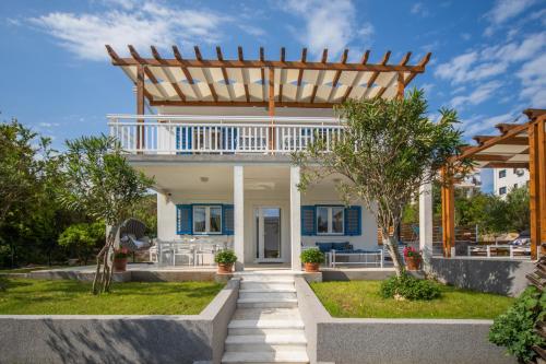 a home with a pergola and a yard at Villa Gioia in Tivat