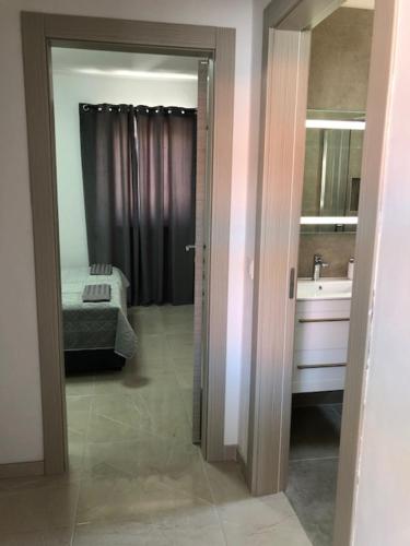 a bathroom with a bed and a sink and a mirror at Ulika Novalja in Novalja