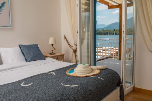 a bedroom with a bed with a hat on it at Villa Gioia in Tivat