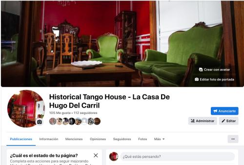 a website of a living room with green chairs and a table at Historical Tango House. Priv area 3 BR /7 guests. in Buenos Aires