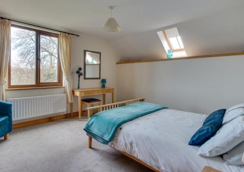 a bedroom with a bed and a desk at Noyadd in Builth Wells