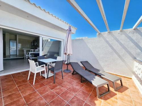 a balcony with a table and chairs and a table at Ocean View Villas Canarias in Adeje
