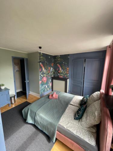 a bedroom with a bed and a couch in it at Villa Artiz in Dunkerque