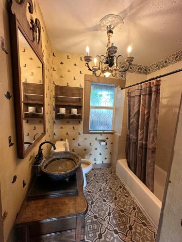 a bathroom with a sink and a tub and a mirror at OQP Vacations Cottage in Miami