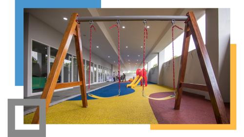 a play area with swings in a building at Apartemen Altiz Bintaro J in Mencil