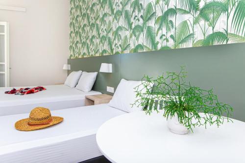 a hotel room with two beds with a hat on them at Sunshine Studios in Malia