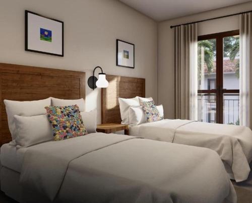 a hotel room with two beds and a window at Eco Resort QUINTA SANTA BÁRBARA in Pirenópolis