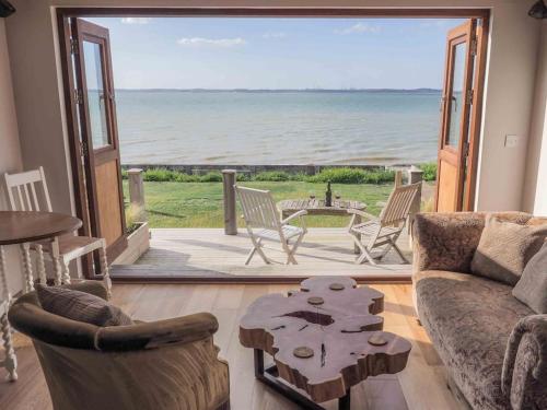 a living room with a view of the ocean at Beachside chalet 4 Cormorant with access to beach in Cowes