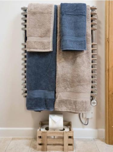a group of towels hanging on a wall at Beachside chalet 3 Cormorant with access to beach in Cowes