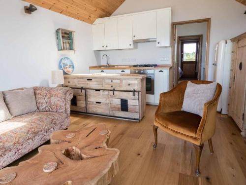 a living room with a couch and a table at Beachside chalet 4 Cormorant with access to beach in Cowes