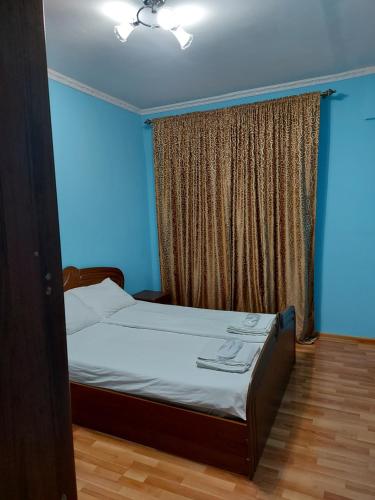 a bedroom with a bed and a window at Апартаменты Denis in Gudauta