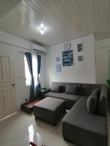 a living room with a couch and a window at CAMILA Homes Transient house /vacation house in Butuan