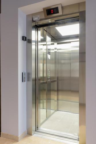 a glass elevator door in a building at Hotel Leonessa in Brescia