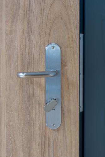 a close up of a metal door handle on a wooden door at Hotel Leonessa in Brescia