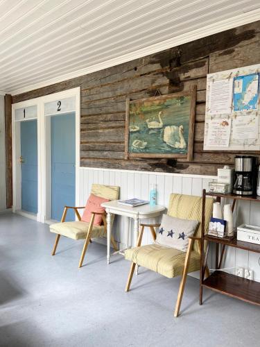 a room with two chairs and a table at Wästinn in Vöyri
