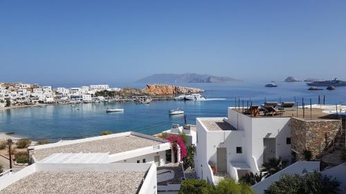 a view of a harbor with boats in the water at Vrahos Boutique Hotel in Karavostasi