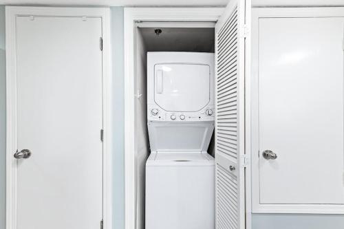 a washer and dryer in a white closet at Clearwater 1D in Gulf Shores