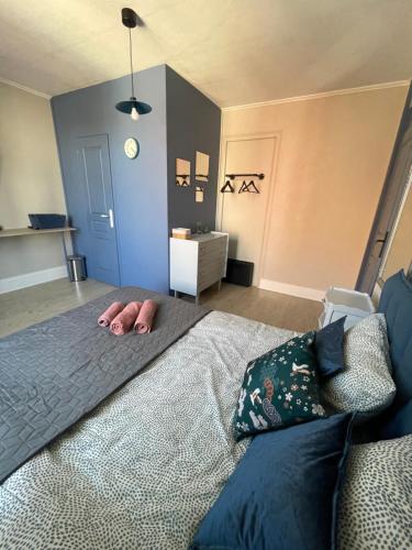 a bedroom with a bed with a person laying on it at Villa Artiz in Dunkerque