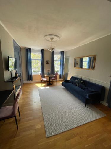 a living room with a blue couch and a table at Villa Artiz in Dunkerque